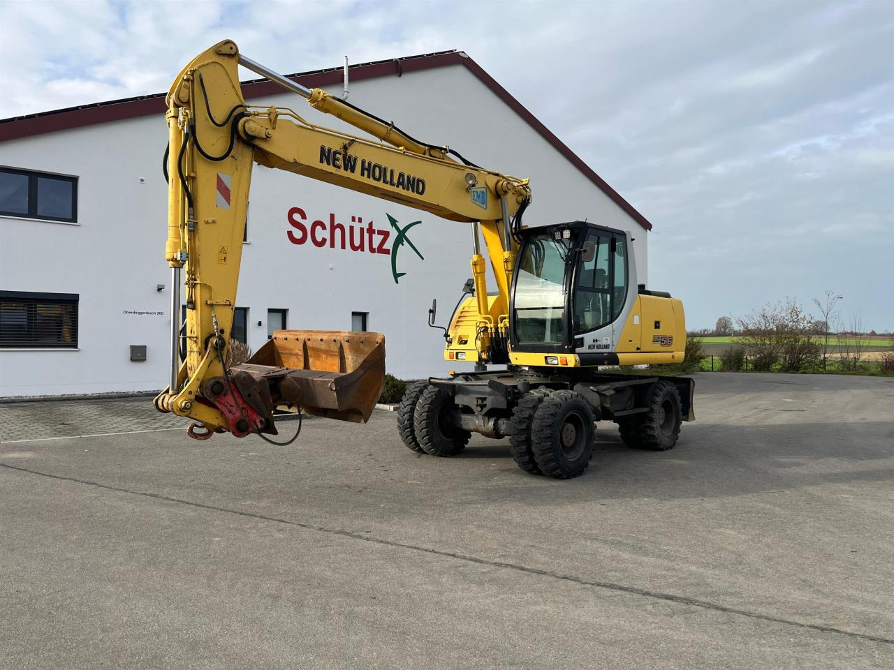 New Holland MH 5.6 inkl. Grabenlöffel, Tieflöffel - Колёсный экскаватор: фото 1 New Holland MH 5.6 inkl. Grabenlöffel, Tieflöffel - Колёсный экскаватор: фото 1