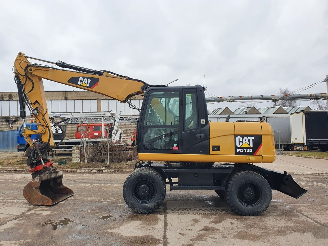 Caterpillar M 313 D Tiltrotator - Колёсный экскаватор: фото 1 Caterpillar M 313 D Tiltrotator - Колёсный экскаватор: фото 1