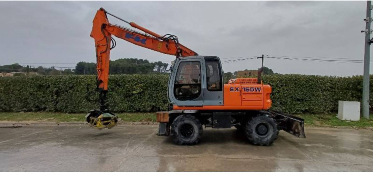 FIAT ALLIS / NEW HOLLAND EX165W - Колёсный экскаватор: фото 1 FIAT ALLIS / NEW HOLLAND EX165W - Колёсный экскаватор: фото 1